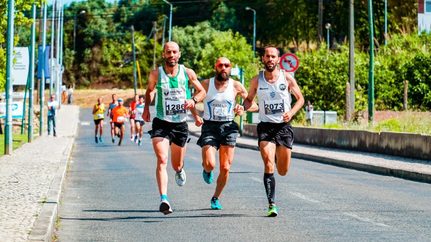 three people are running in a marathon