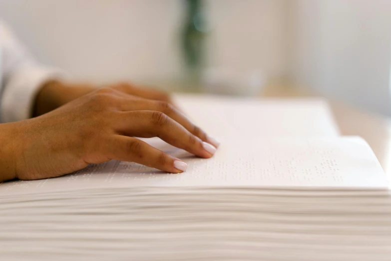 a close up of a person's hand on a book, a photocopy, by Carey Morris, unsplash, background image, piles of paperwork, programming, white paper