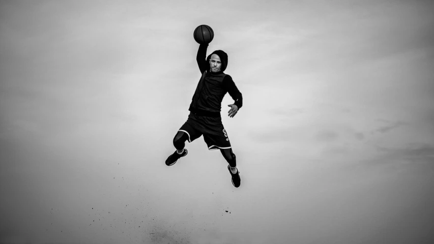 a man that is jumping in the air with a basketball, a black and white photo, 15081959 21121991 01012000 4k, childish, man in black, air shot