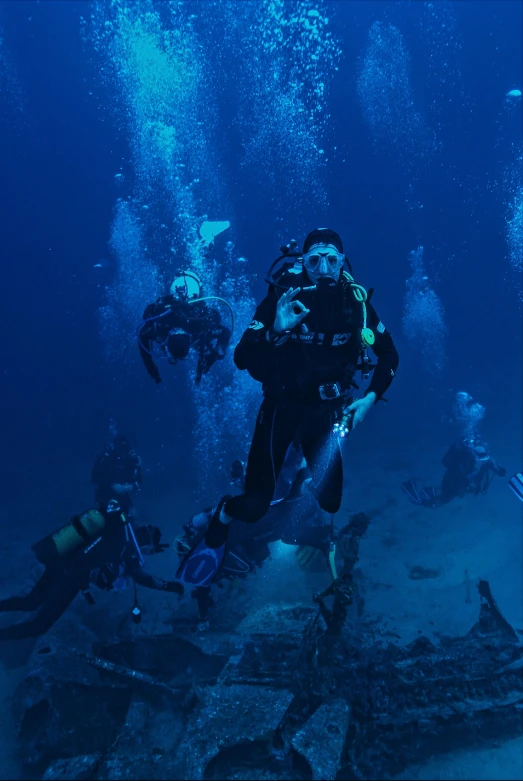 a group of people diving in the ocean, at the bottom of the ocean, deep environment, deep sea themed, touring