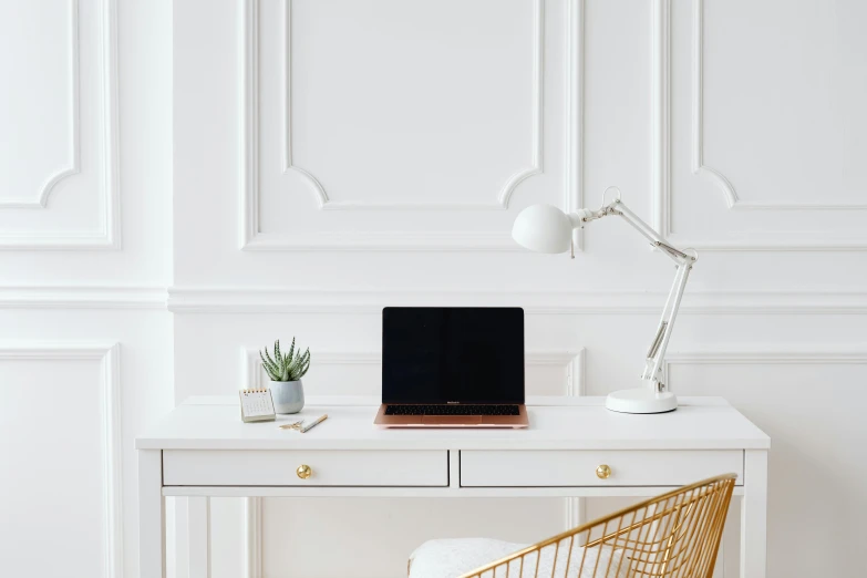 a laptop computer sitting on top of a white desk, by Julia Pishtar, trending on pexels, intricate gold linework, white room, smooth panelling, in white room
