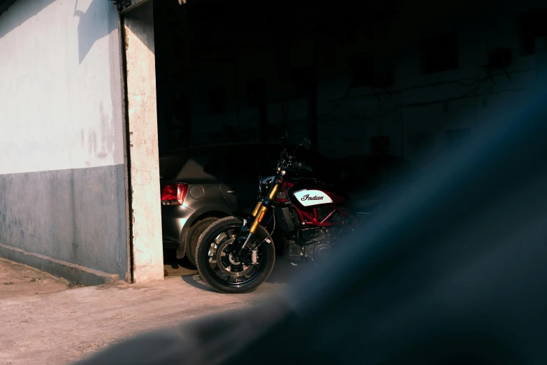 a motorcycle parked next to a building in the dark