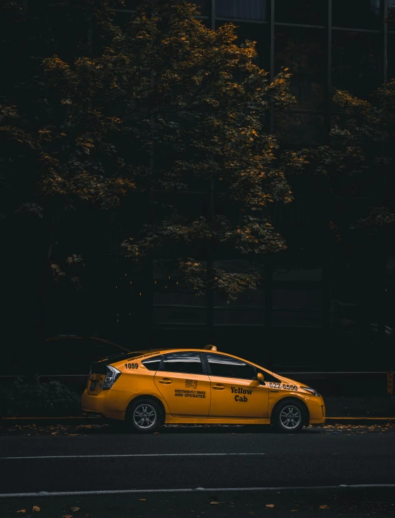 a taxi cab sitting in front of a tall building