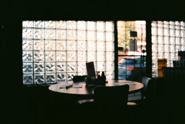 a view of a table, the back lighting is cast on the wall