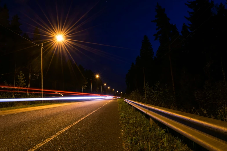 a long exposure photo of a street at night, by Thomas Häfner, unsplash, fan favorite, highway 5 0, forest at night, summer lighting