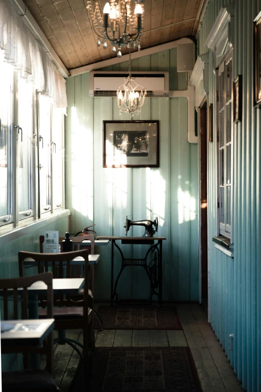 this is the inside of a restaurant with sunlight streaming through