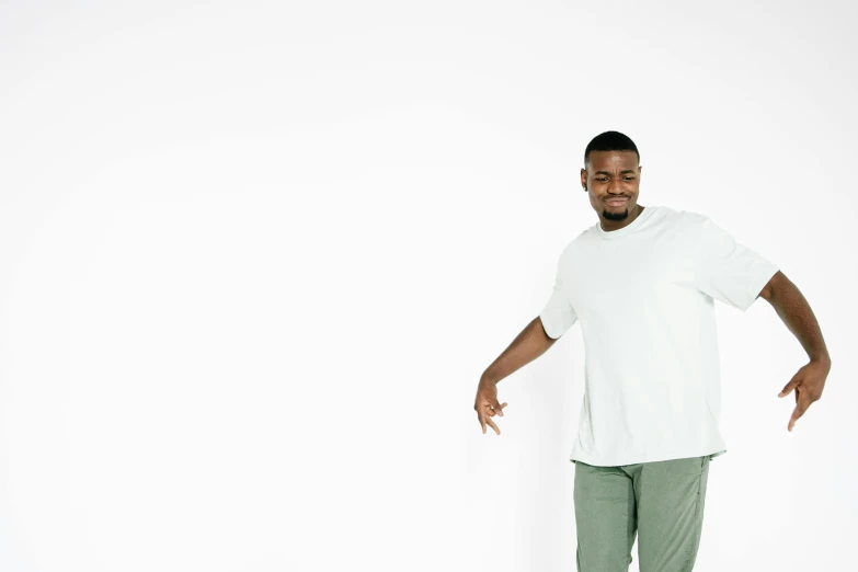 a man in white is smiling while standing with his foot spread out