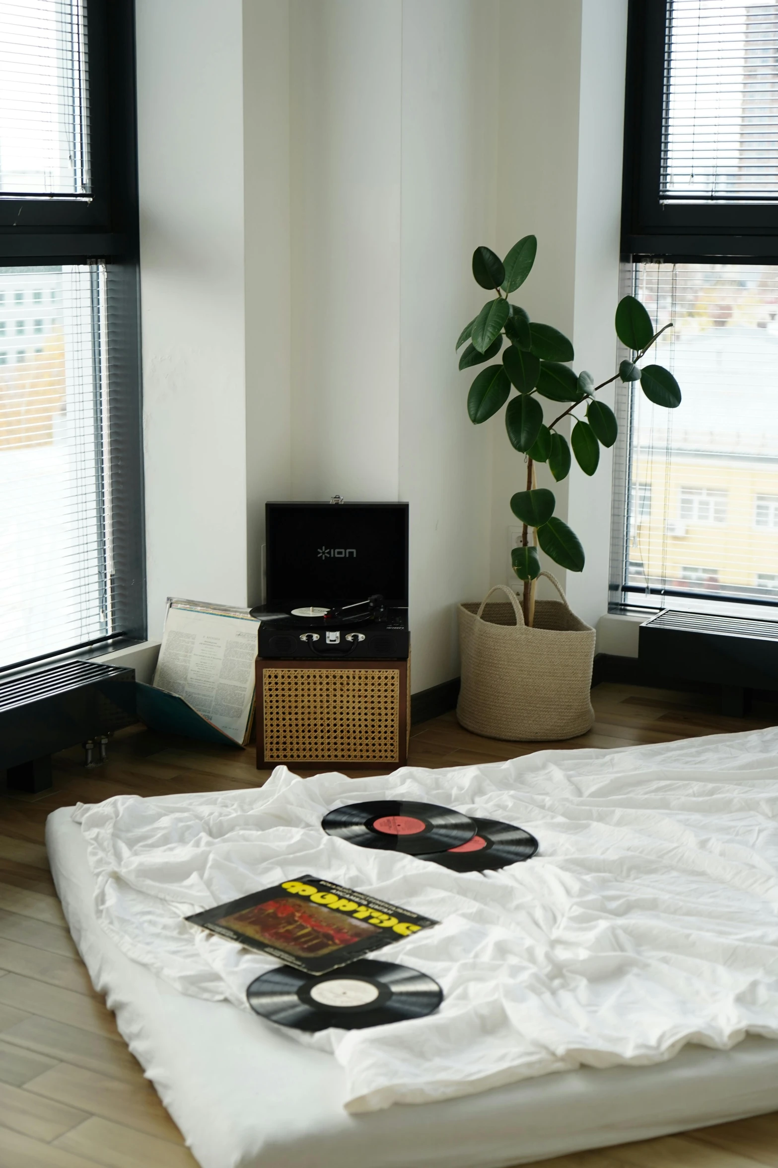 a bed in a room with many windows