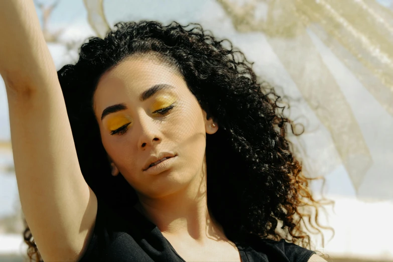 a close up of a person with a umbrella, wavy hair yellow theme, egypt makeup, portrait featured on unsplash, on a sunny day