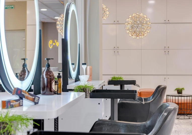 several chairs and mirrors in a hair salon