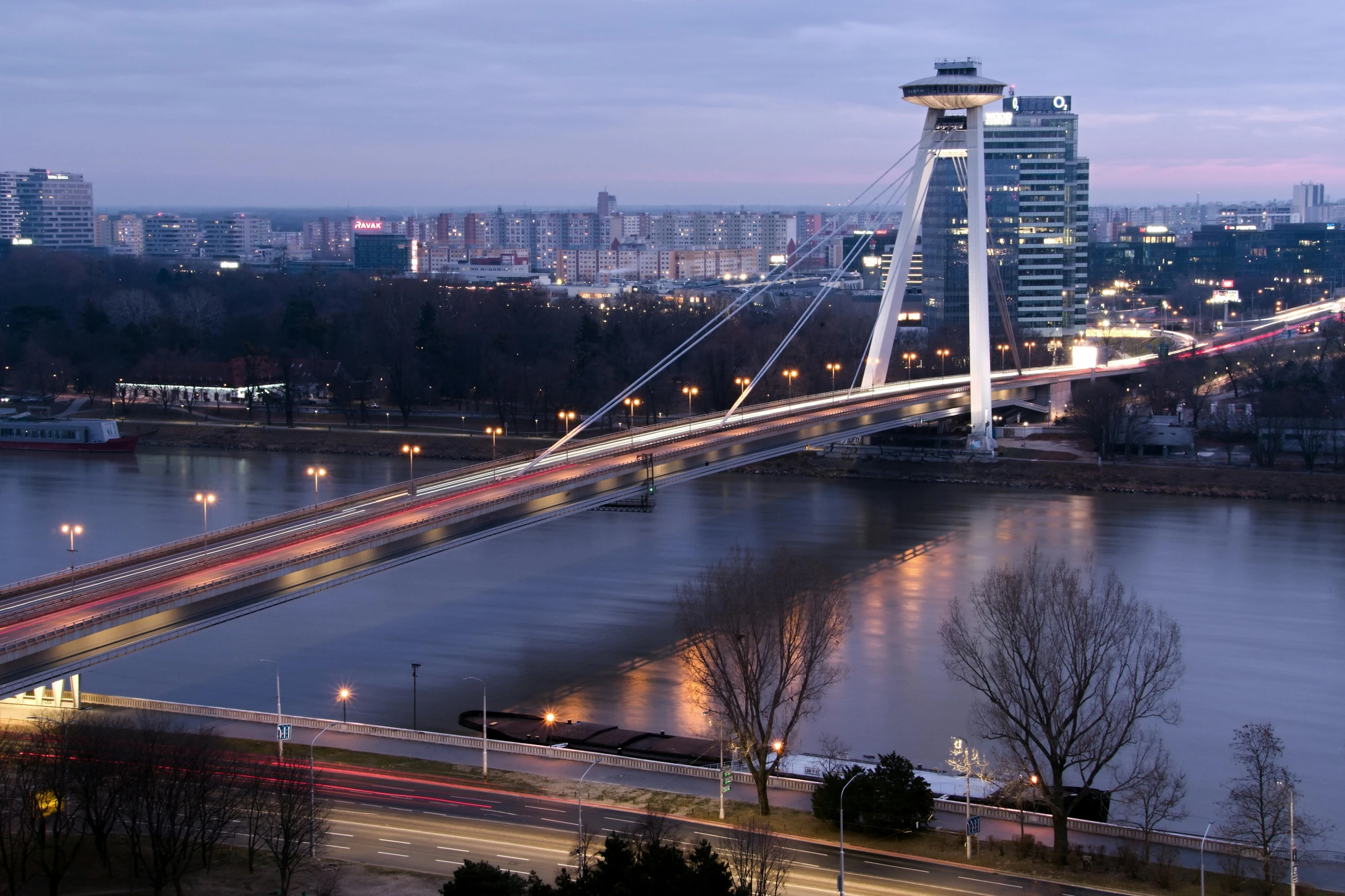 a bridge over a body of water with a city in the background, by László Balogh, pexels contest winner, happening, daniel libeskind, slovakia, slide show, led