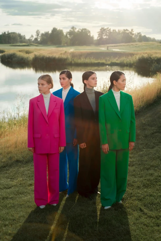 a group of people standing next to a body of water, inspired by Vanessa Beecroft, color field, wearing a suits, meadow, young women, promotional image