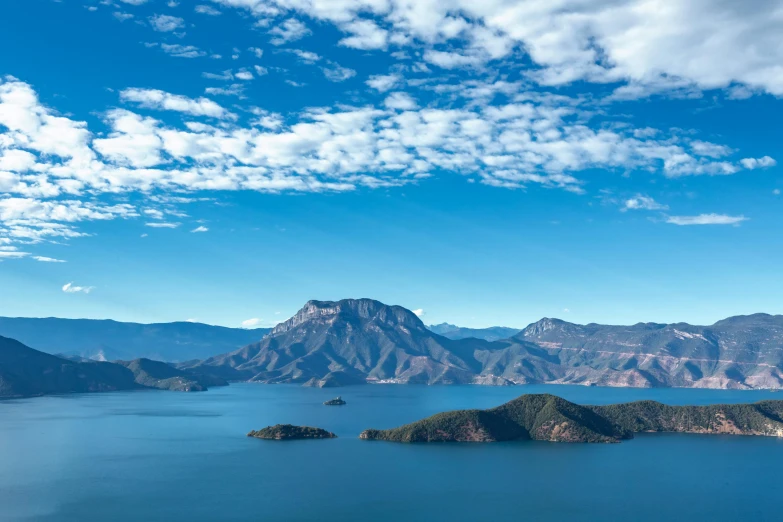 the mountains are very near the water with one boat