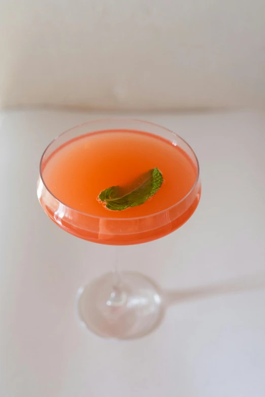 a close up of a drink in a glass on a table, gushy gills and blush, ignant, mint, striking pose