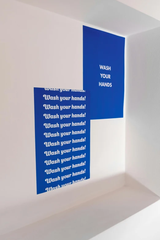 a bathroom with blue and white signs on the wall, inspired by Yves Klein, unsplash, interactive art, hands, instructions, diecut, thumbnail