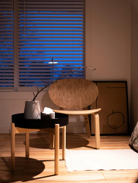 a chair sitting in front of two vases near one another