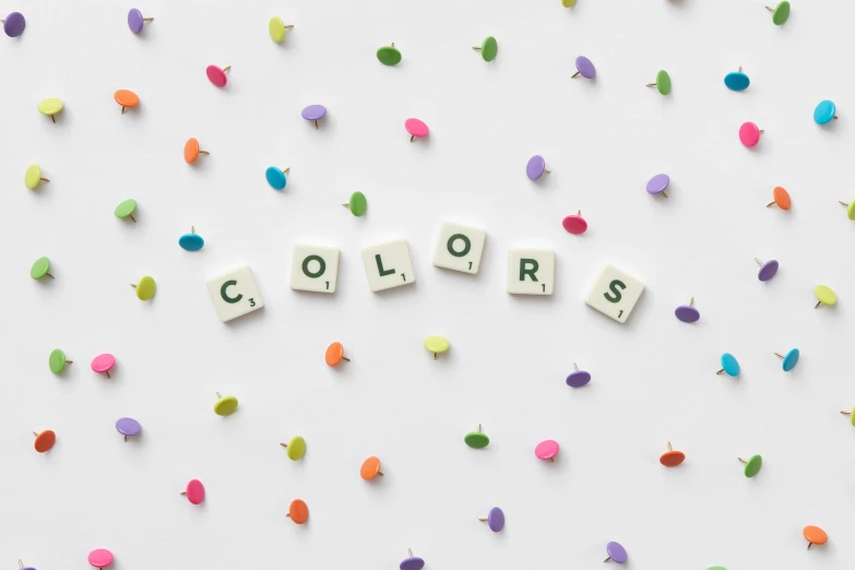 colorful confetti sprinkles are scattered around the word colors, inspired by Ellsworth Kelly, trending on unsplash, color field, beige colors, whie tcolor, color ( sony a 7 r iv, color blocks