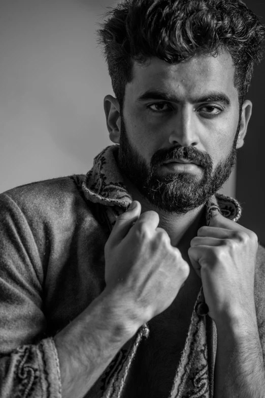 a black and white photo of a man with a beard, a black and white photo, by Ismail Acar, pexels contest winner, a portrait of rahul kohli, herry cavill, casual pose, square