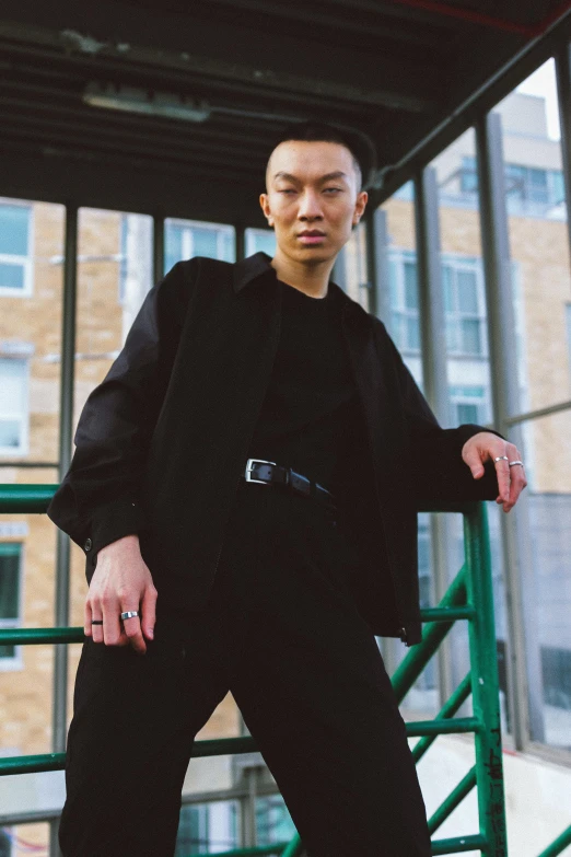 a man in a black shirt and black pants, unsplash, louise zhang, non binary model, photographed for reuters, rectangle