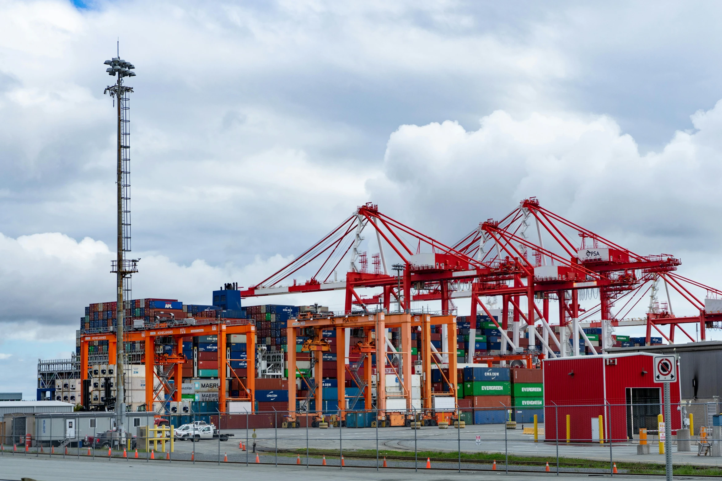 a large container ship sitting on top of a body of water, vancouver, huge machine cranes, avatar image, unedited