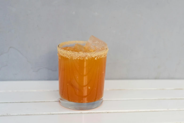 a close up of a drink in a glass on a table