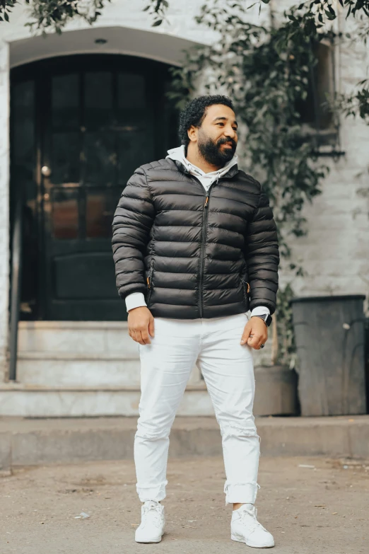 a man standing in front of a building, model wears a puffer jacket, fan favorite, profile image, wearing pants