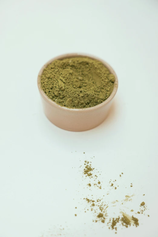 a bowl of powder sitting on top of a table, green plant, product image, pot leaf, in a medium full shot