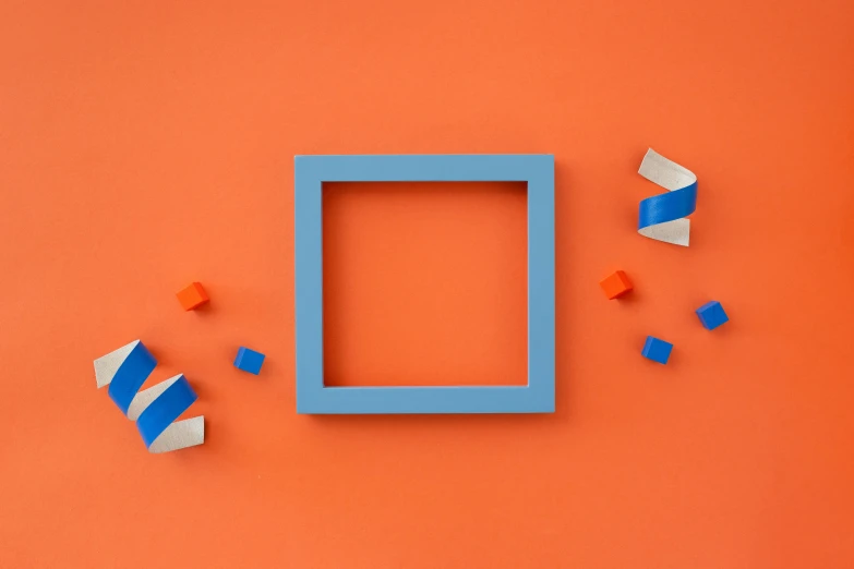 a blue frame sitting on top of an orange wall, an abstract sculpture, inspired by Josef Albers, pexels contest winner, square shapes, toys, motion graphic, a wooden