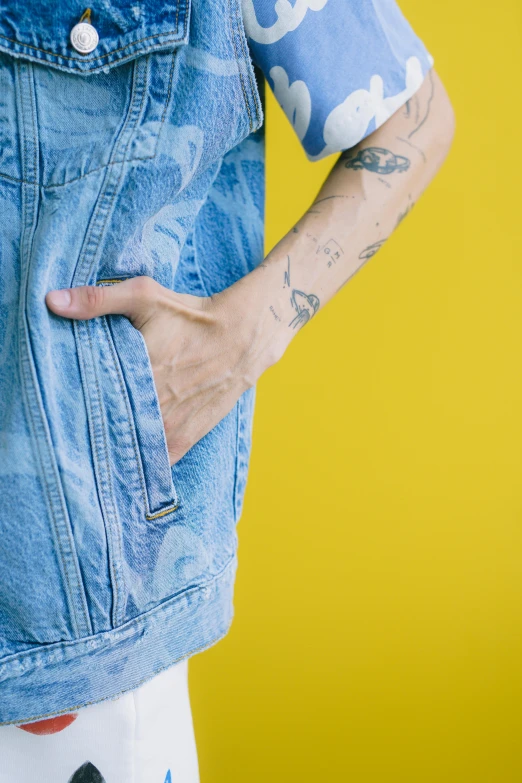 a man's tattooed arm showing his jeans