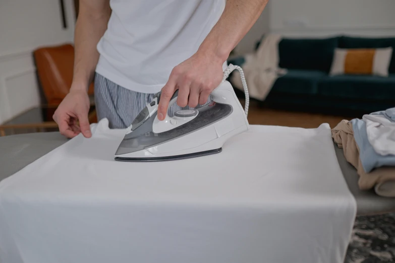 a person ironing on top of a table