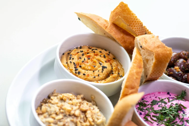 a variety of food sitting in bowls on a plate