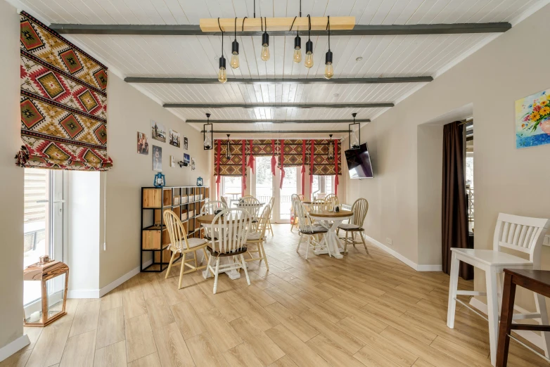 the large dining room has chairs and tables