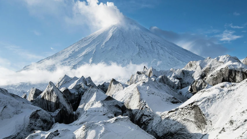 the snow capped mountains of japan stand against the blue sky