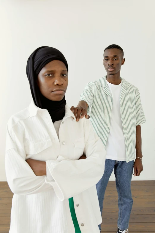 two people standing next to each other in a room, by Ellen Gallagher, african ameera al taweel, default pose neutral expression, battle pose, ( ( theatrical ) )