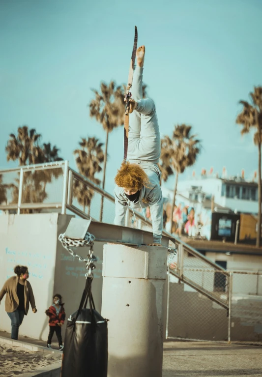 a man flying through the air while riding a skateboard, a colorized photo, by Niko Henrichon, pexels contest winner, happening, santa monica beach, an ahoge stands up on her head, bored ape yacht club, live performance