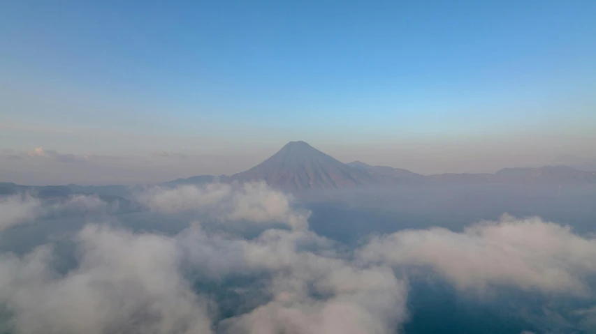 aerial view of mountain above cloud in blue sky