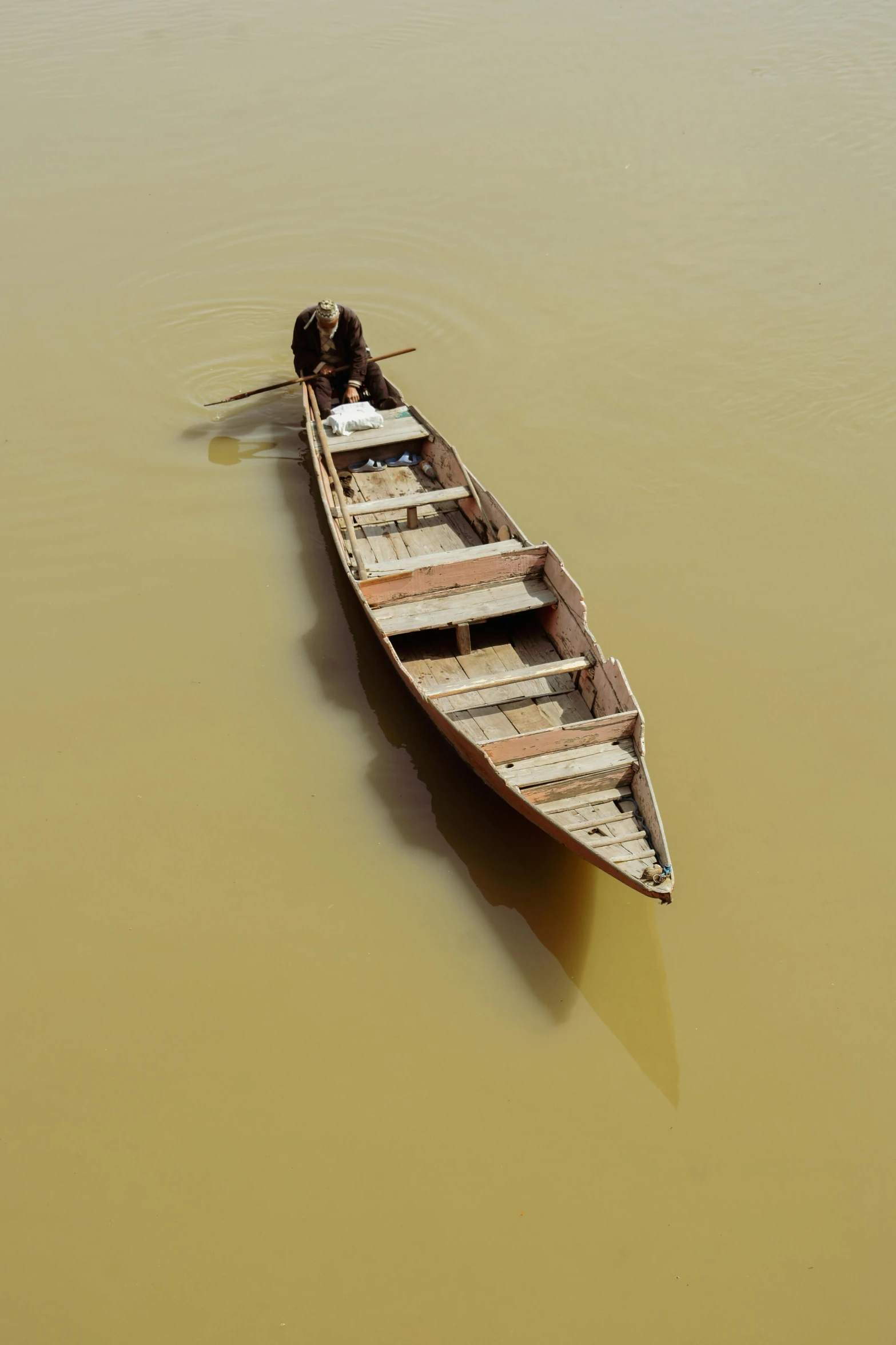 a small boat floating on top of a body of water, by Peter Churcher, slide show, bangladesh, ochre, high - angle view