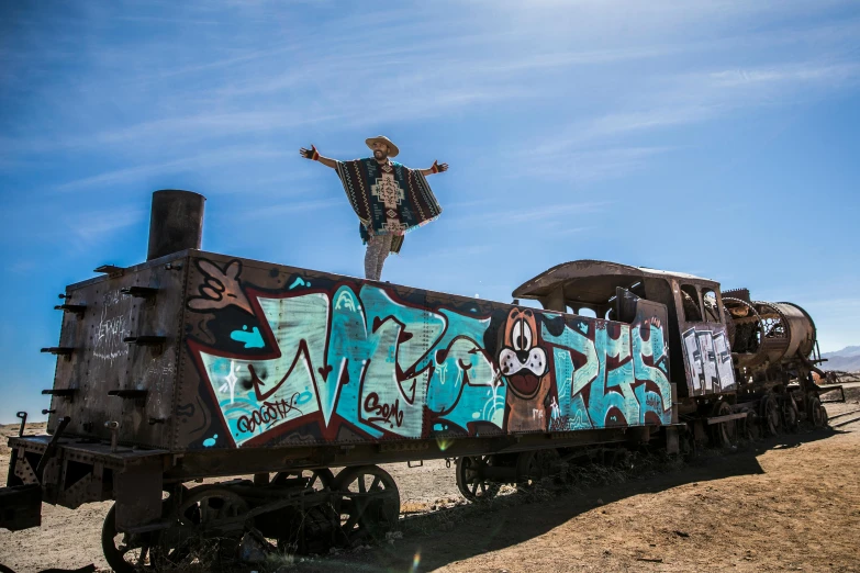 a man standing on top of a train covered in graffiti, by Jessie Algie, misty ghost town, dabbing, blue sky, photobash
