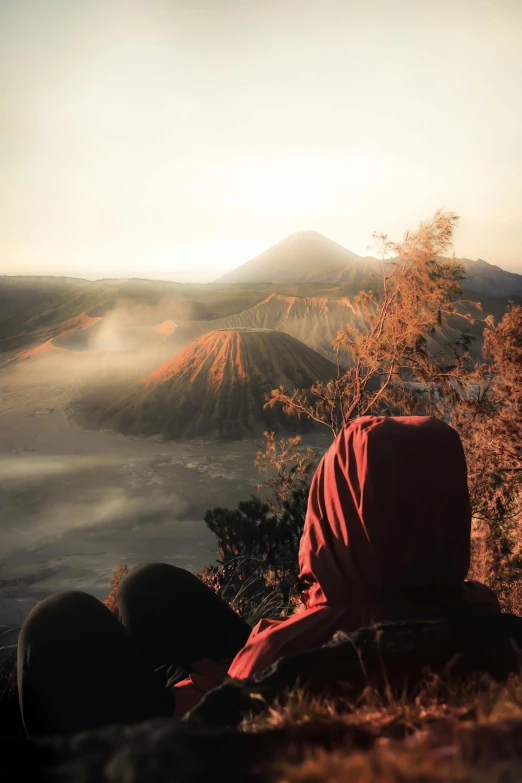 the man is watching the sunset on the mountain