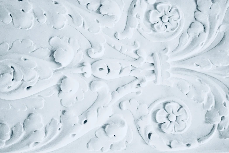 a close up of a decorative design on a wall, a marble sculpture, inspired by Louis Eilshemius, pexels contest winner, baroque, white backround, white and pale blue, chalky, white plastic