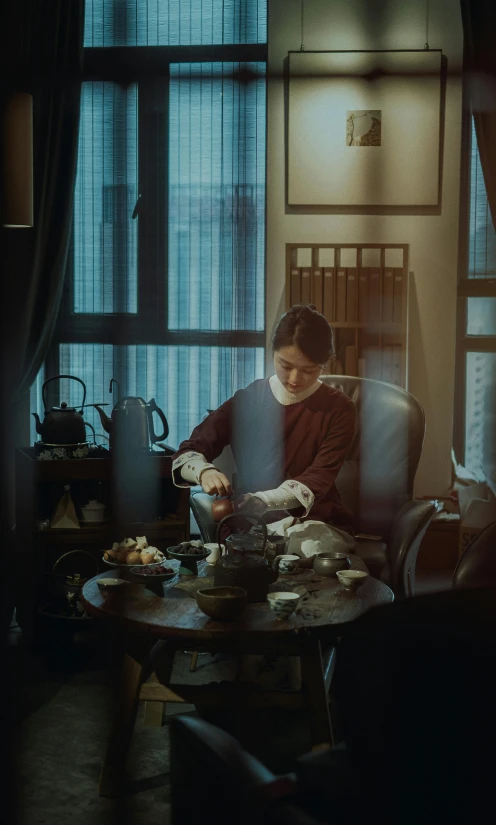 a man sitting at a table in front of a window, inspired by Gu An, pexels contest winner, palace ， a girl in hanfu, working in her science lab, scene from a dinner party, ( ( theatrical ) )