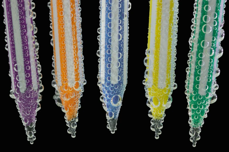 a close up of a bunch of beads on a string, a stipple, inspired by Bruce Munro, featured on zbrush central, test tubes, pencils, water droplets, 3 colours