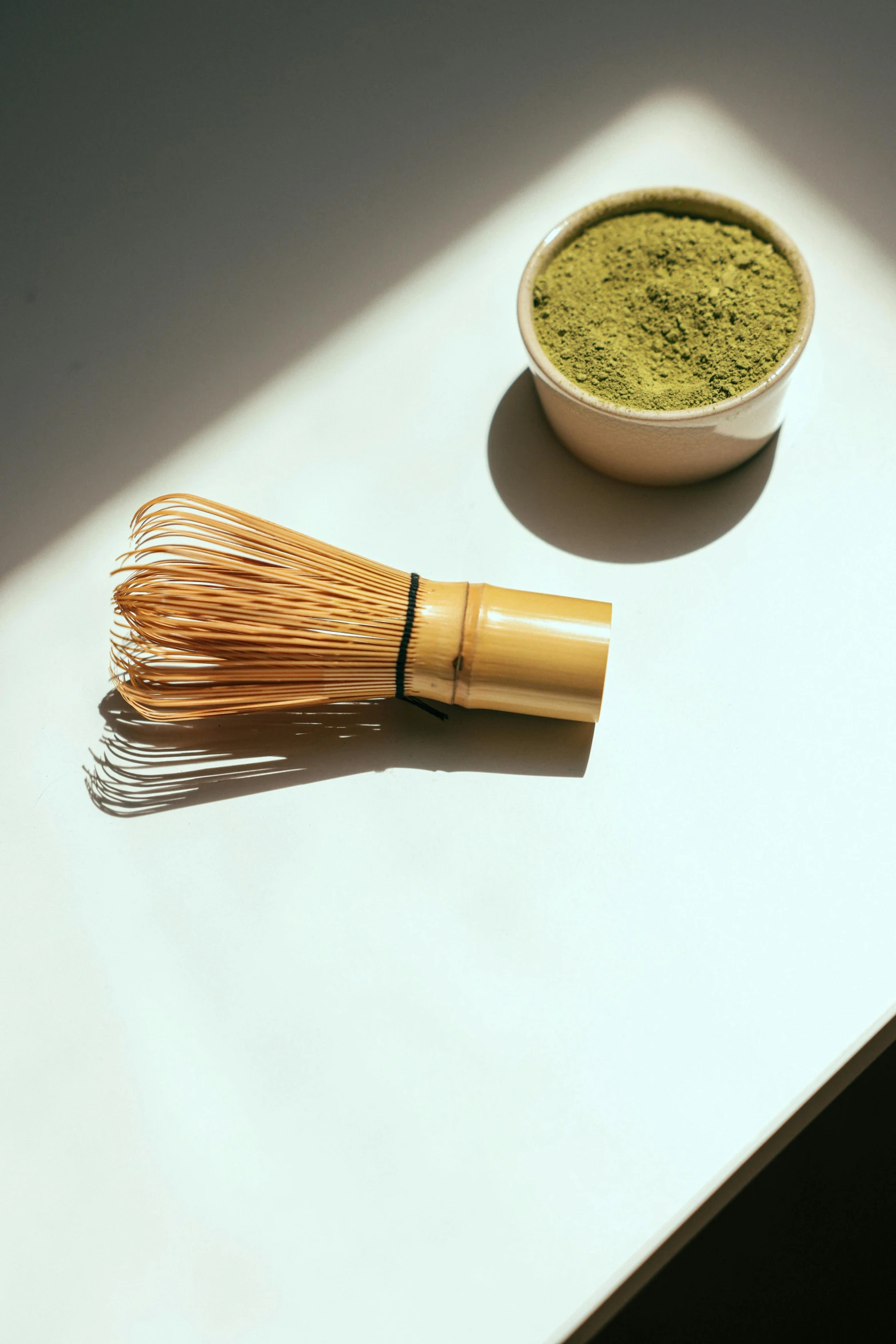 a whisk next to a bowl of matcha, inspired by Kanō Shōsenin, sunlight, bay area, focus on full - body, gold