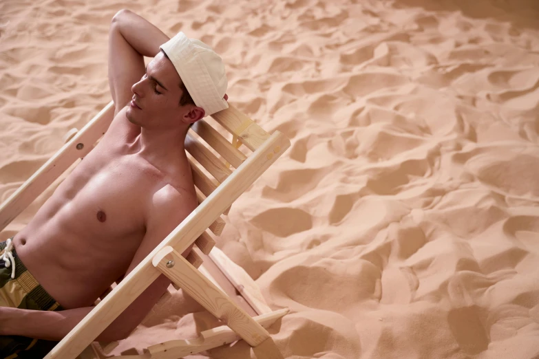 a shirtless man sitting in a chair on a beach, pexels contest winner, renaissance, sand color, with a white complexion, profile image, mars vacation photo