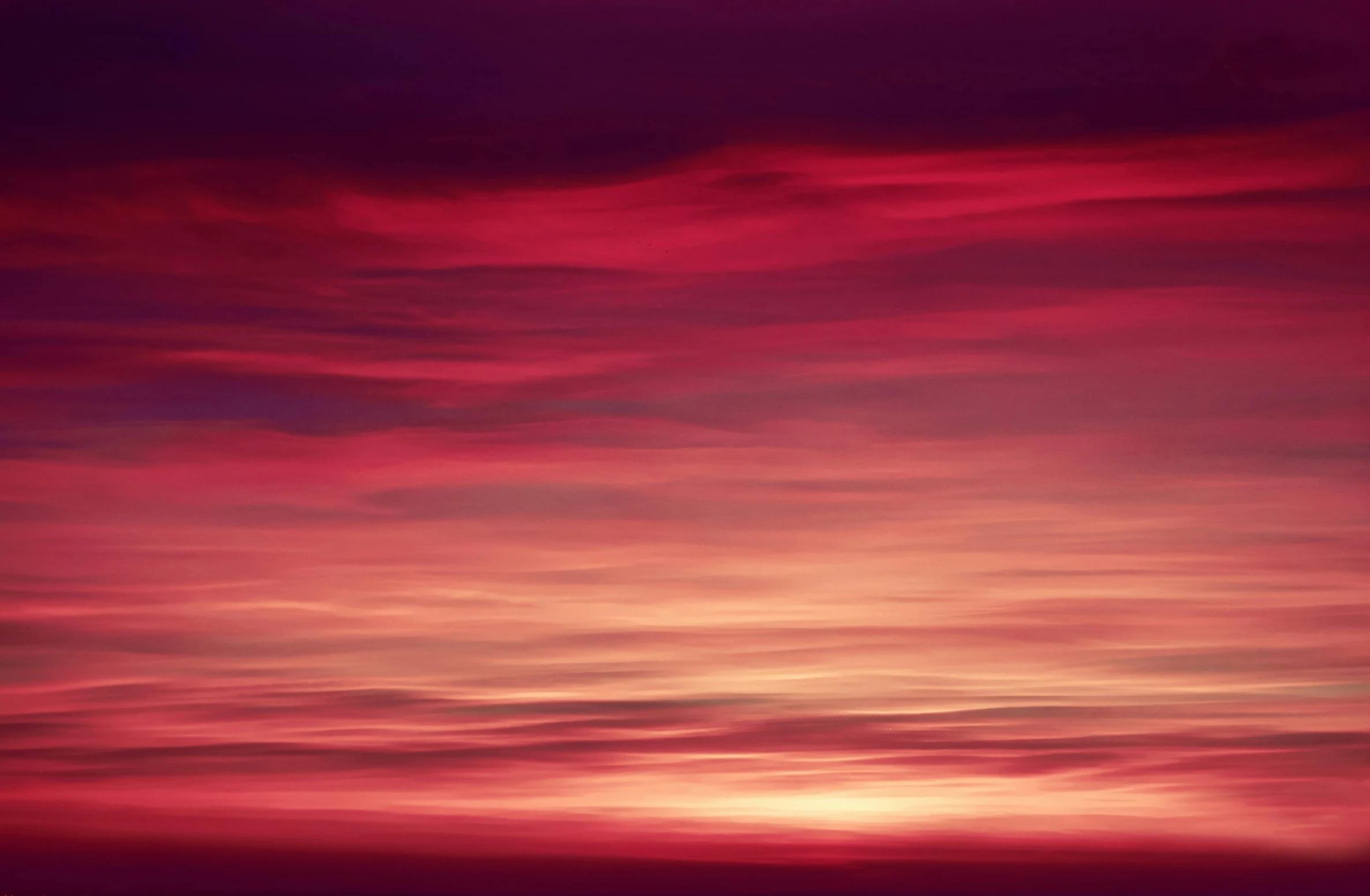 a very colorful sunset over some water with the moon in the background