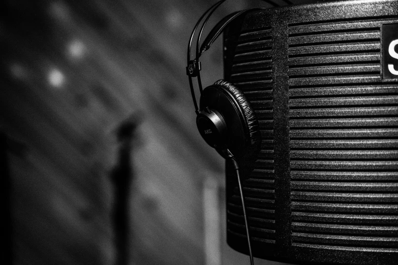 a close up of a microphone with headphones on, by Konrad Witz, gritty image, panel of black, studio quality product, background image
