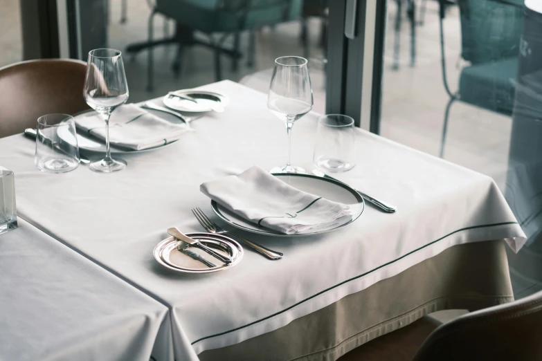 a table that has a white table cloth on it, by Daniel Gelon, unsplash, renaissance, stainless steal, diner, grey, front and center