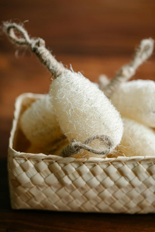 a basket filled with white wools on top of a wooden table, inspired by Max Buri, unsplash, dragon fruits, sponge, bath, hanging