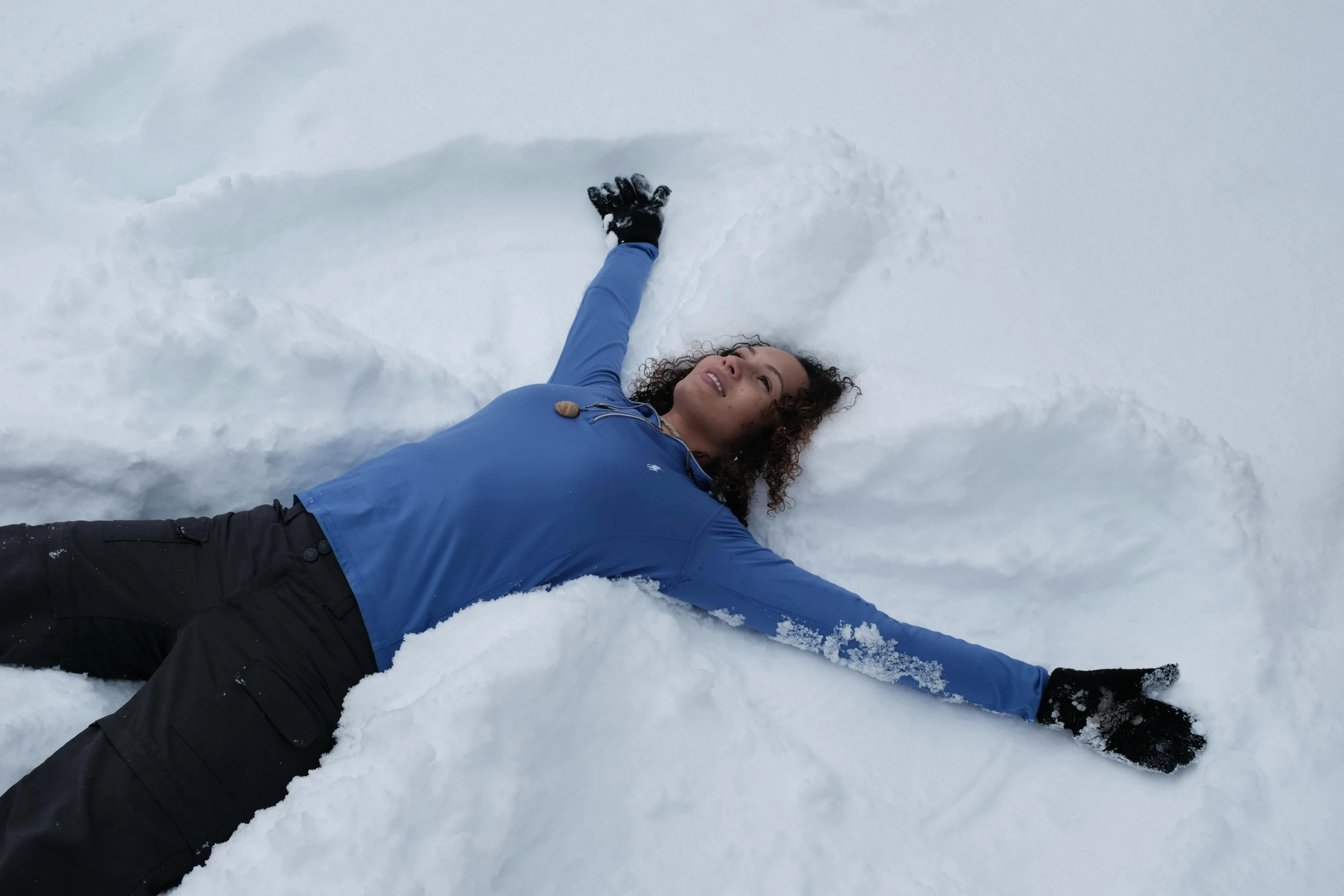 a woman laying in the snow making a snow angel, pexels contest winner, avatar image, no cropping, profile picture, group photo