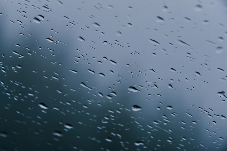 a close up of a window with raindrops on it, trending on unsplash, hyperrealism, blue tinted, thumbnail, photorealistic octane render 8 k, gray sky